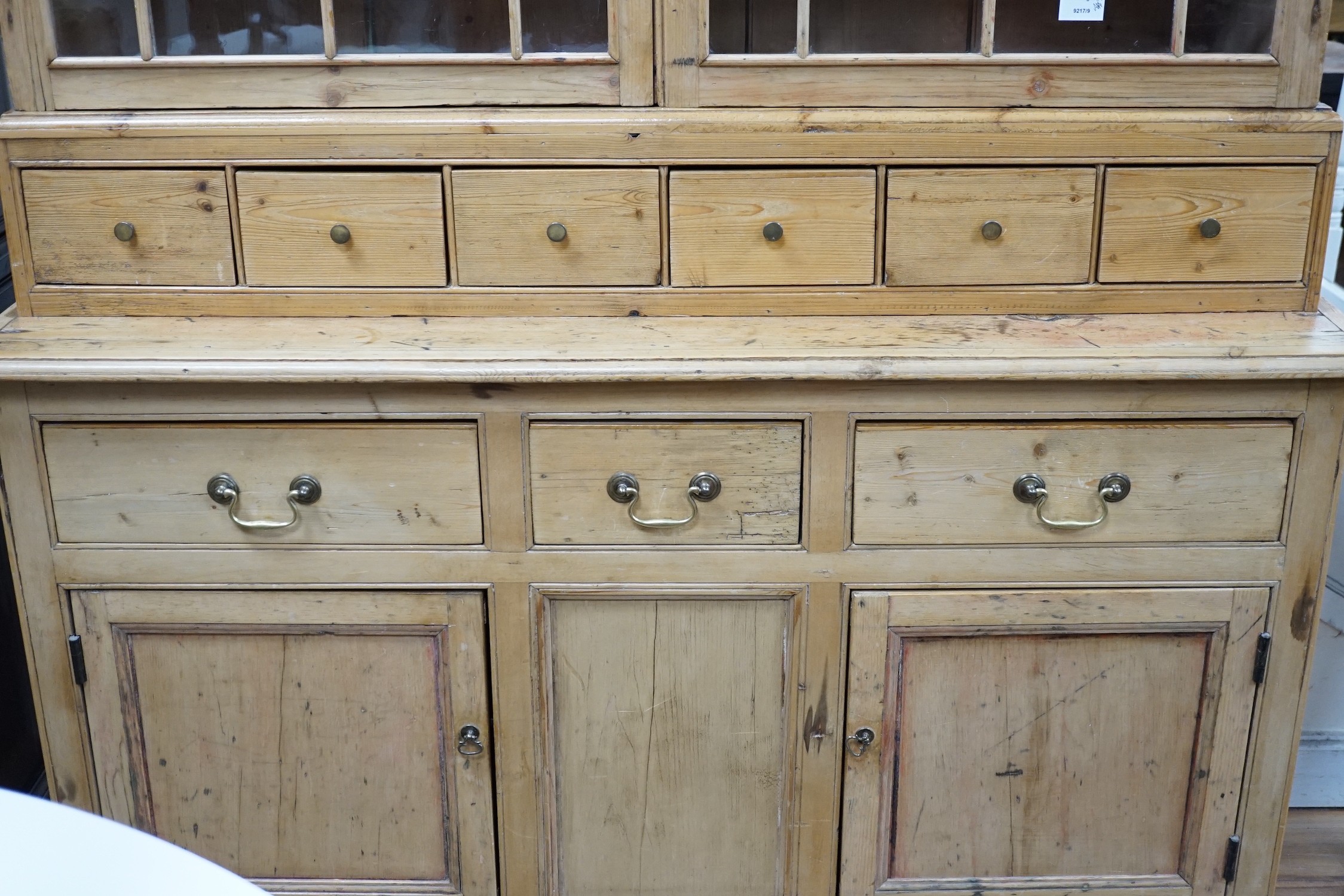 A 19th century pine dresser base of small proportions with an associated glazed cabinet top, width 133cm, height 185cm *Please note the sale commences at 9am.